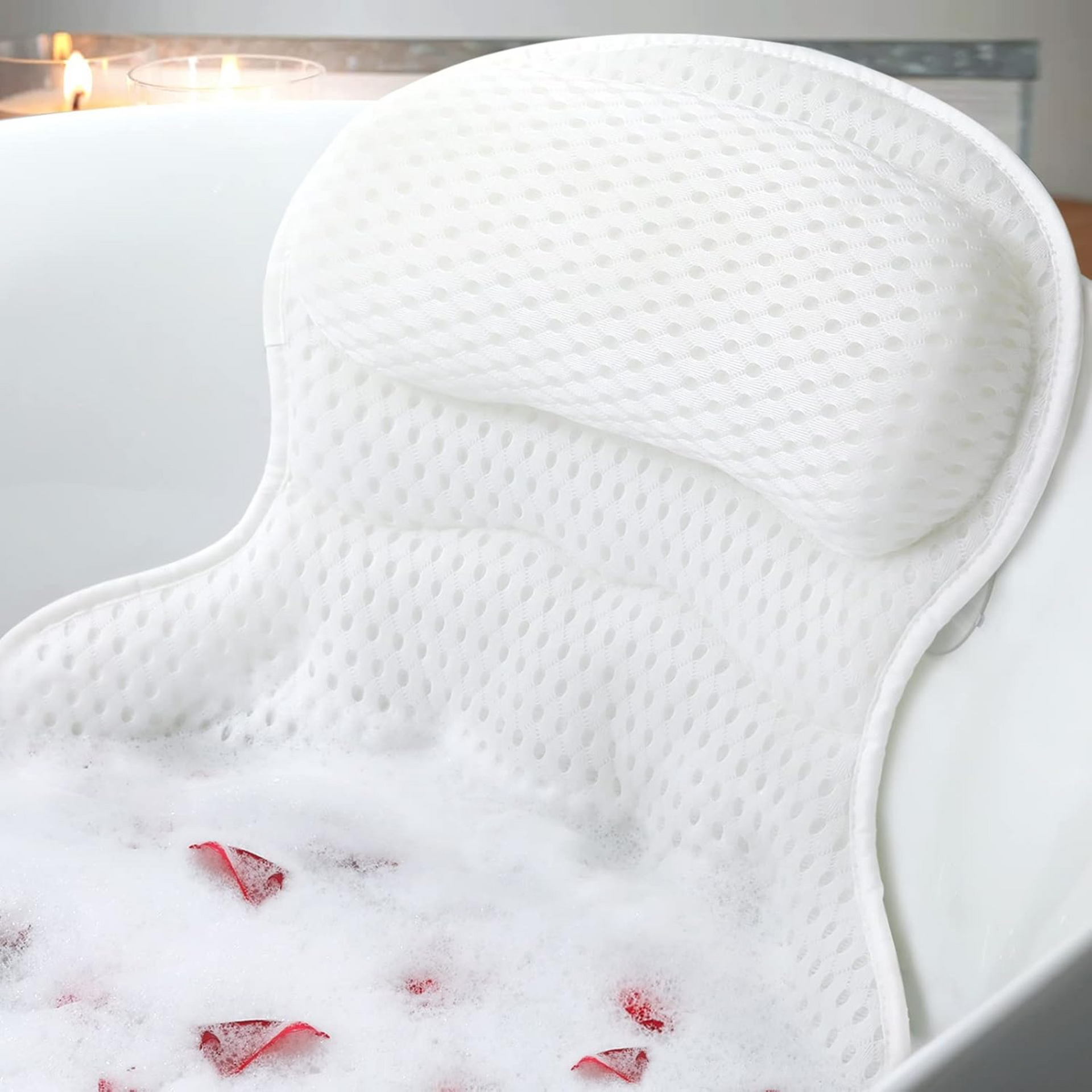 Ozyalo bath pillow for tub in white 4D mesh with ergonomic headrest and back support, shown in a relaxing bubble bath.